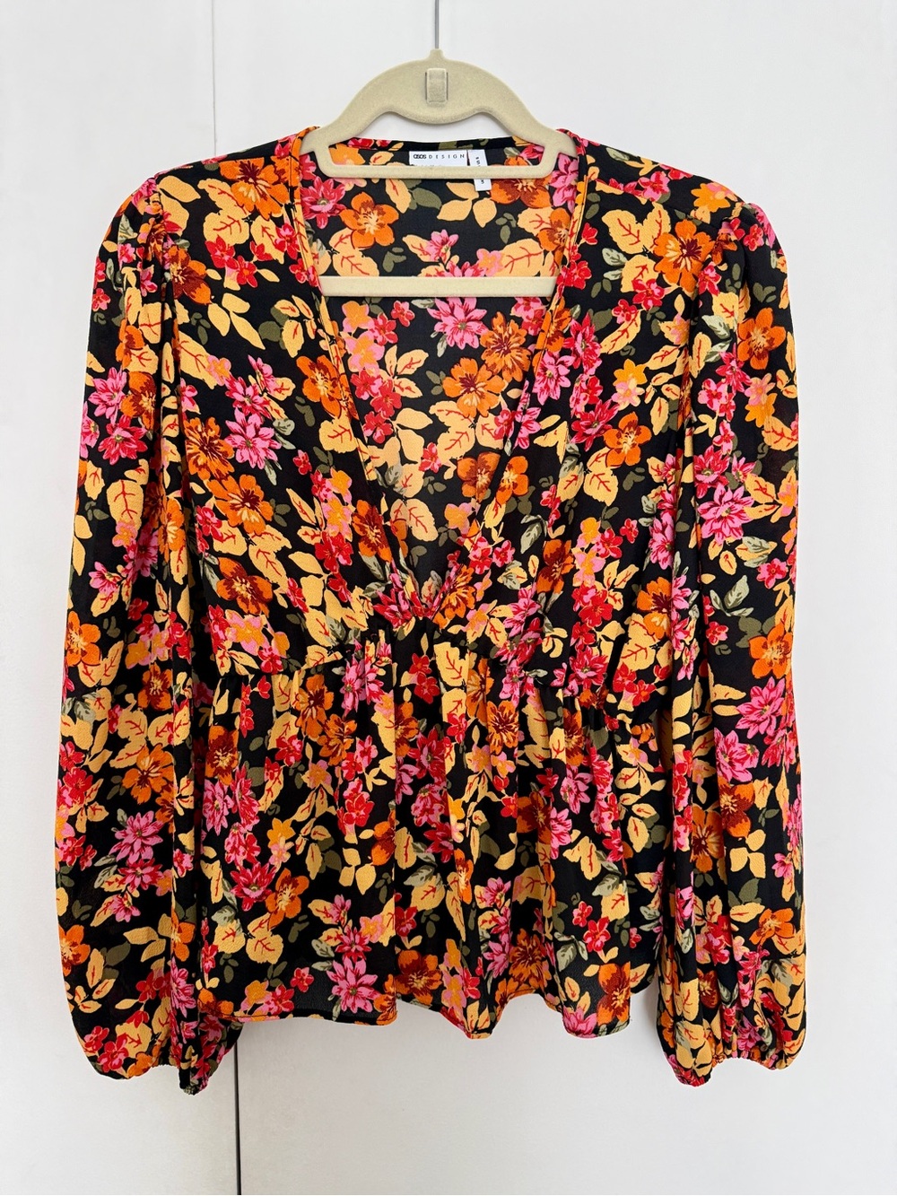 ASOS Design Sheer V-Neck Volume Sleeve Top with Pepulm Hem in black floral